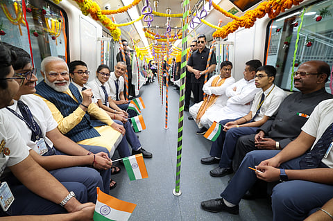 A picture of Prime Minister Narendra Modi travelling in India first underwater metro along with students