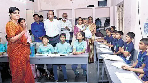 A file photo of District Collector Dasari Hari Chandana interacting with students seated in a U-shaped layout in Hyderabad