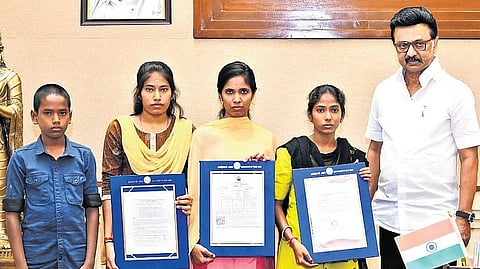 Chief Minister M K Stalin along with the four orphaned children from Poottai village in Kallakurichi who were presented with welfare aid on Monday.