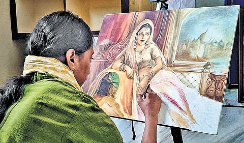Dhanalakshmi at work on a canvas at her home in Villupuram district