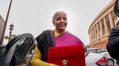 Finance Minister Nirmala Sitharaman with the digital tablet, enclosed in a traditional red 'bahi-khata' style pouch, at the Parliament premises before the presentation of the Union Budget 2026-27, in New Delhi, Sunday, Feb. 1, 2026.