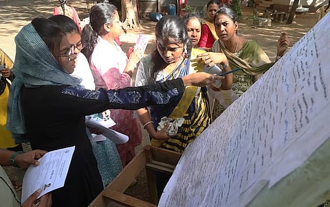 Candidates checking the hall numbers inside TNPSC exam centre in Madurai, June 2025.