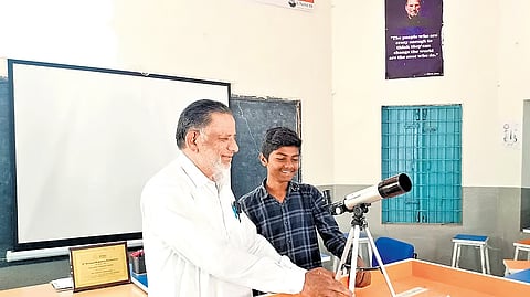 Md Javed, a Hindi teacher at the Government High School in Savaran, explains the working principle of a telescope to his student, Syed Hanif.