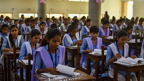As CHSE plus two exams begins, students at an examination venue write their first paper at Ramadevi Women's University in Bhubaneswar