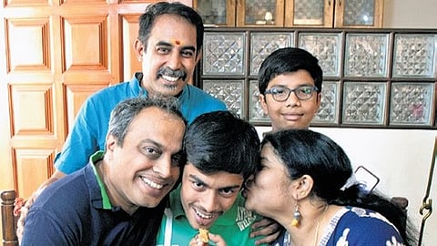 Bengaluru’s Dhanush Sudhir Mysore celebrates with his family his perfect score of 625, on Thursday.