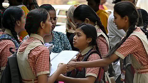 Students arrive to give their SSLC examination at a State government school in Bengaluru