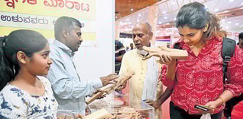 A visitor checks out products at a stall set up as part of the Global Agritech Summit 2026 organised by FKCCI at Palace Grounds in Bengaluru on Friday