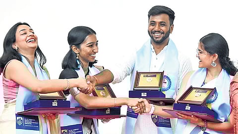 Gold medalists greet each other during the second convocation of Dr BR Ambedkar Economics University, in Bengaluru on Monday.