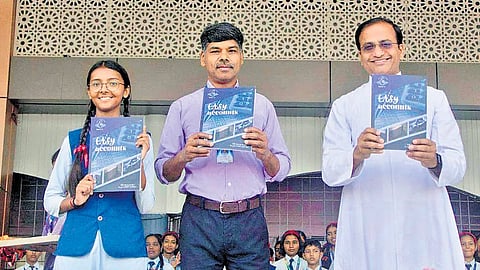 ‘Easy Accounts’ book being released by Fr John Joseph Vadakkel CST, principal of Little Flower School, Harayya, Uttar Pradesh. The author Santu P A is also seen