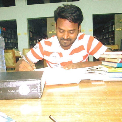 Muthukrishnan at his study desk in happier times | Facebook