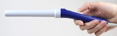 The device has a colposcope design with lights and a camera at one end