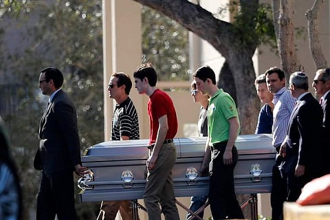 Family and students carry the casket of Scott Beigel, one of the three teachers who died rescuing students at Marjory Stoneman Douglas High School | AP
