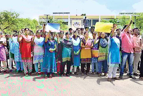 Students protest in front of Madurai Kamaraj University, demanding action against the teacher