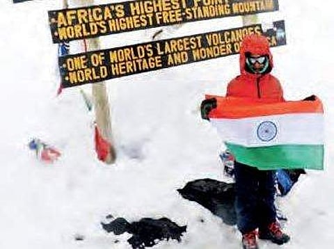 Samanyu at Uhuru peak of Mount Kilimanjaro in Tanzania, the highest peak in Africa