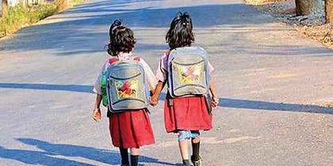 Children carrying heavy school bags