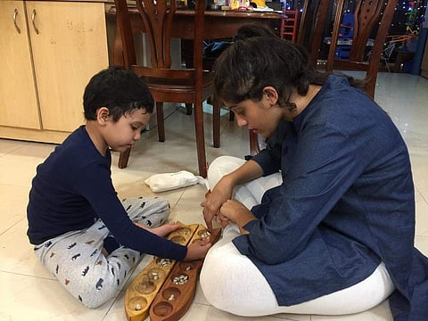 Tanvi Mainkar playing a game called Ali Guli Mane along with the younger kid at her home (Pic: Tanvi Mainkar)
