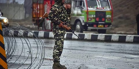 A soldier guards the suicide bomb attack site at Awantipora in Pulwama. (Photo | PTI)