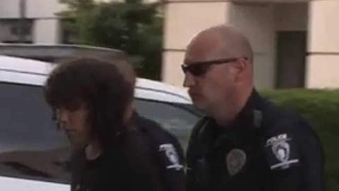The suspect being led out of campus
