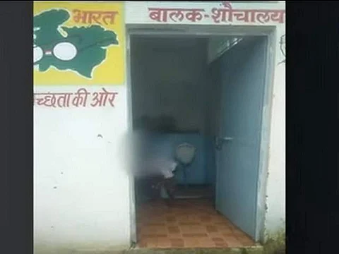 A videograb shows children cleaning toilets (Pic: Social Media)
