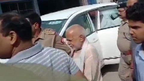 Swami Chinmayanand being escorted by the police (Pic: Twitter)