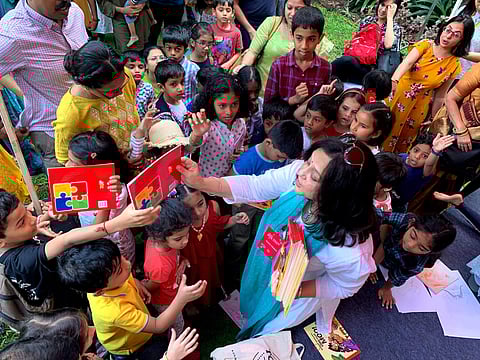 Rohini Nilekani handing over books to kids at one of the literature festivals
