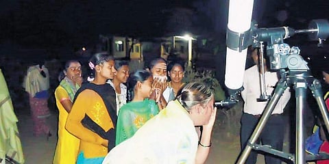 Locals view the Jupiter-Saturn conjunction through a telescope (Pic: Express)