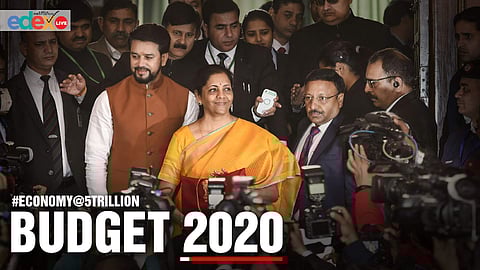 Union Finance Minister Nirmala Sitharaman, flanked by her deputy Anurag Thakur (to her right) and a team of officials, shows a folder containing the Union Budget documents| Pic: Edexlive