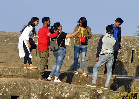 Youngsters click photographs during their visit to Rajhunsgad near Yellur, Belagavi