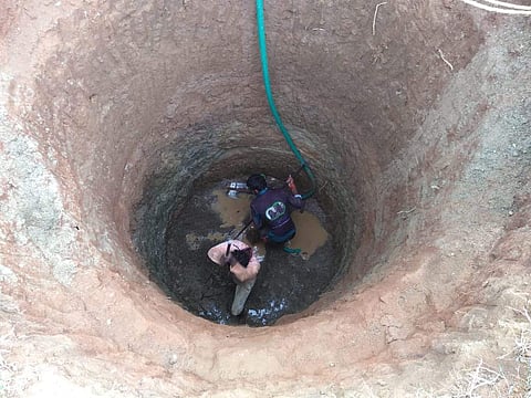 Well diggers cleaning the well