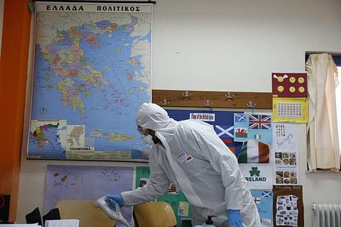 A school classroom in Athens being sprayed with disinfectant| Pic: AP