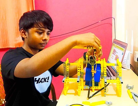 Yuva working on the sanitiser dispenser