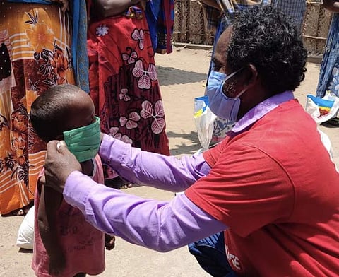 A volunteer helping a child put on the mask | (Pic: Rapid Response)