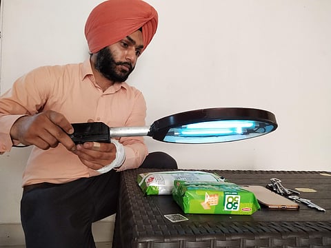 Professor Mandeep Singh holding the UV racket
