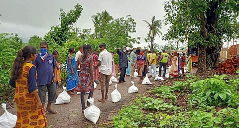 People receiving grocery bags from volunteers (Pics: The Akshaya Patra Foundation)