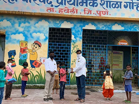 Students being given tablets at school