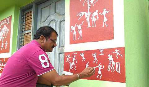 Santosh Kumar giving a final touch of paint on the school walls (Picture: Santosh Kumar)