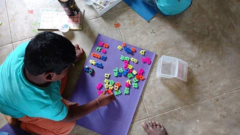 A boy learning to arrange Kannada letters (Pics: Gubbachi Learning Community)