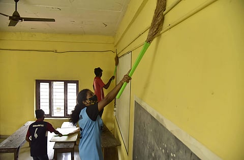 Volunteers engage in cleaning the premises at HSS Eloor in Kochi | Pic: Albin Mathew