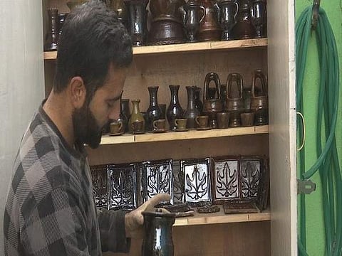 Mohammad Umar Kumar showcasing his art work | Pic: ANI
