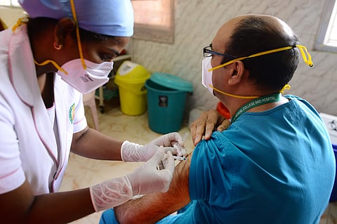 A health worker prepares injecting Covishield vaccine to a doctor | Pic: Express