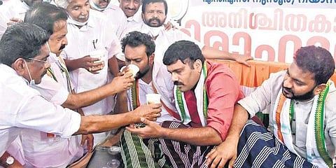 Ramesh Chennithala, Mullappally Ramachandran and Oommen Chandy offer lime juice to Youth Congress vice-presidents N S Nusoor, Rijil Makkutty and Riyas Mukkoli
