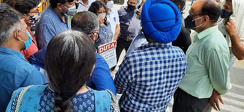 DUTA President Dr Rajib Ray and other teachers talk to VC Dr PC Joshi (in face shield) (Pic: DUTA)