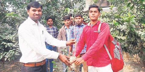 Rajesh Kumar Suman with a student | (Pic: The New Indian Express)