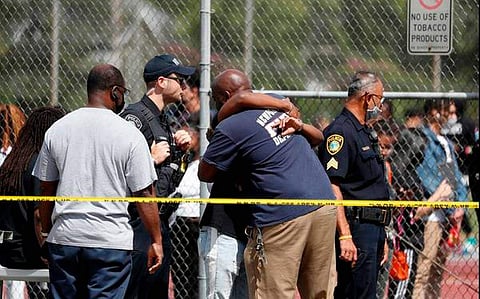 People embrace outside Heritage High School as Newport News Police are on scene responding to a shooting incident on September 20, 2021 in Newport News, Virginia (Pic: AP)