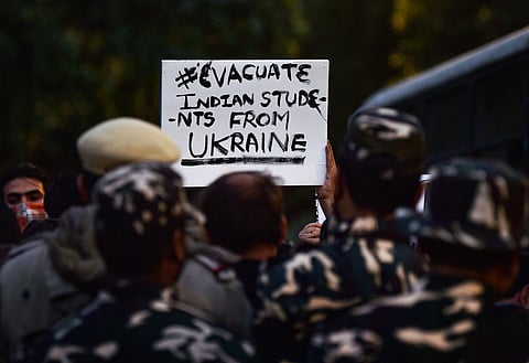 Family members of students stranded in crisis-hit Ukraine display a placard during a protest near the Embassy of the Russian Federation (Pic: PTI)