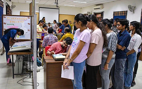 Students stand in a queue as they cast their votes for the Delhi University Students' Union (DUSU) polls 2023, at Miranda House college in New Delhi. (PTI Photo)