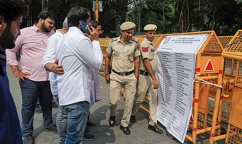 Police personnel stand outside a counting center on the counting day of the DUSU elections, in New Delhi. (PTI Photo)