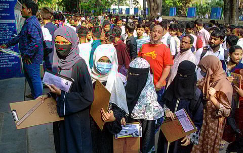 Students wait in a queue as they arrive to appear for the Telangana SSC Class 10th examinations, at an exam centre in Saidabad, on Monday, March 18, 2024. 