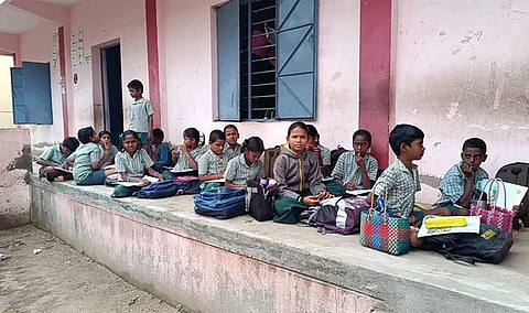 Students seated outside