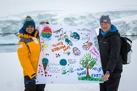 Hand painted cloth banner by kids taken to the end of the world, as a message from Antarctica 